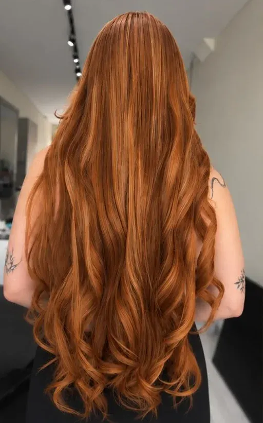 After: long, full copper hair with soft waves