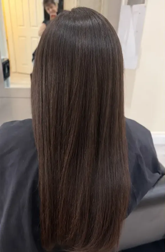 After keratin: smooth, straight dark brown hair